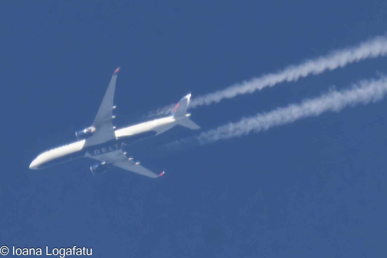 High above the clouds, an airplane soars aloft